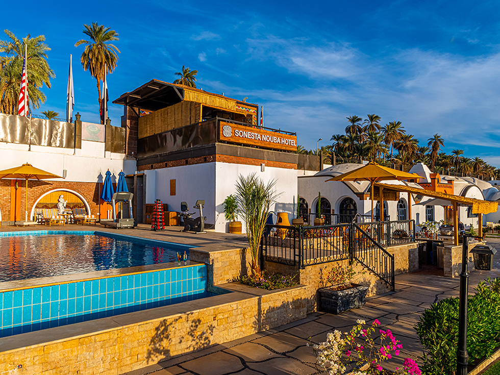 The exterior and pool area at Sonesta Nouba Hotel Aswan.