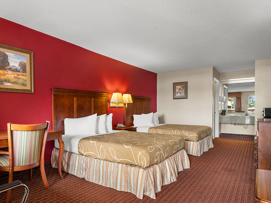 Americas Best Value Inn Montezuma queen bed guest room gallery image