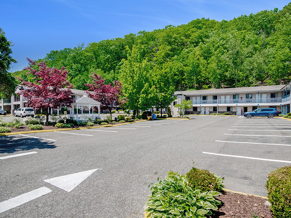 The parking lot and exterior of the Americas Best Value Inn Torrington, CT hotel.