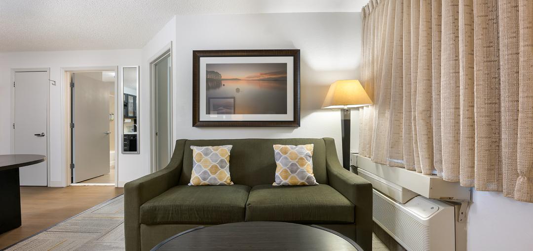 The living space area of Sonesta Simply Suites Huntsville Research Park's One Bedroom Suite.