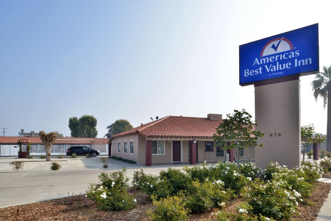Hotel exterior with landscape and sign