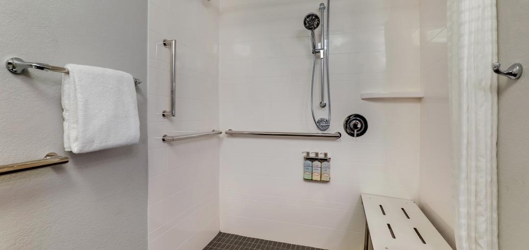 An accessible shower at Sonesta Simply Suites Miami Airport Doral.