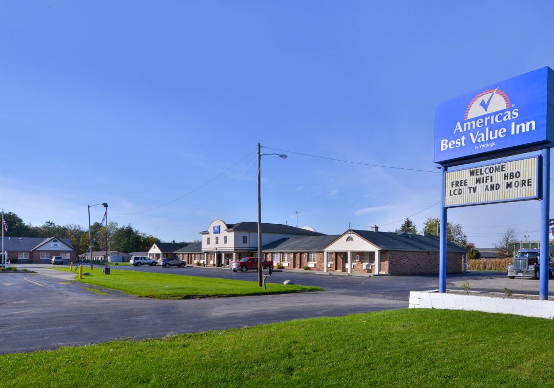 Street view of hotel exterior and sign with lawn area