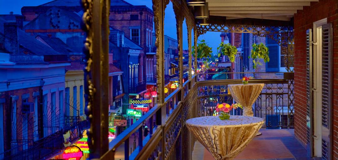 A guestroom balcony overlooking Bourbon Street at The Royal Sonesta New Orleans hotel.