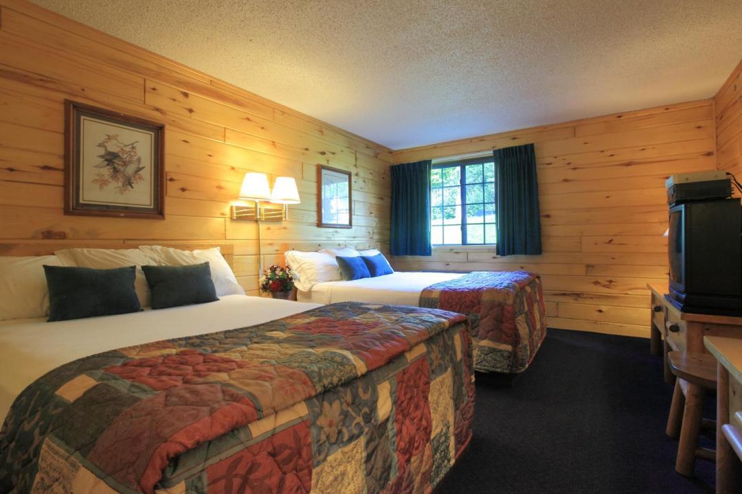 Two bed guest room with wooden walls