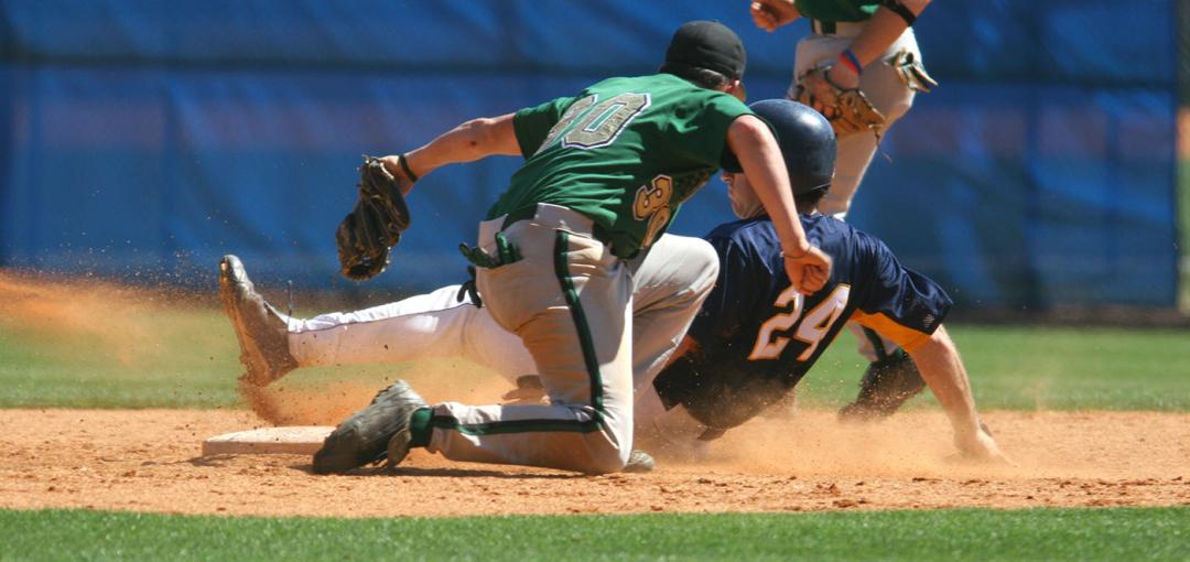 baseball player sliding to plate