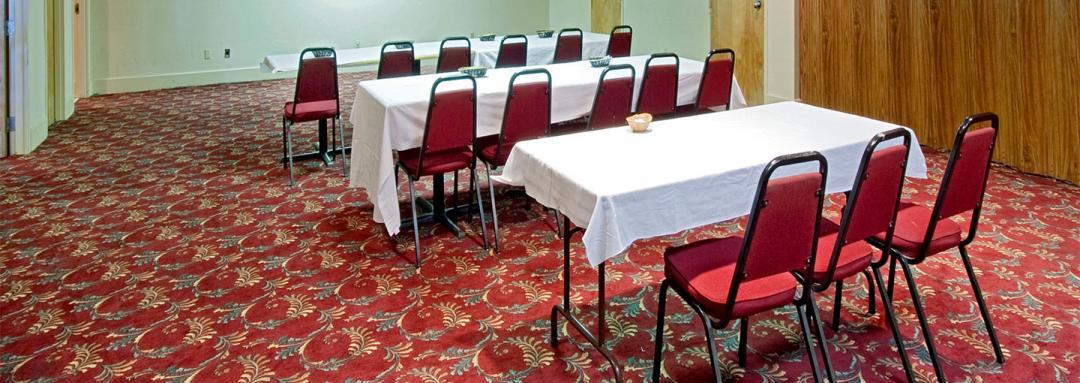 Meeting area with three tables and multiple chairs