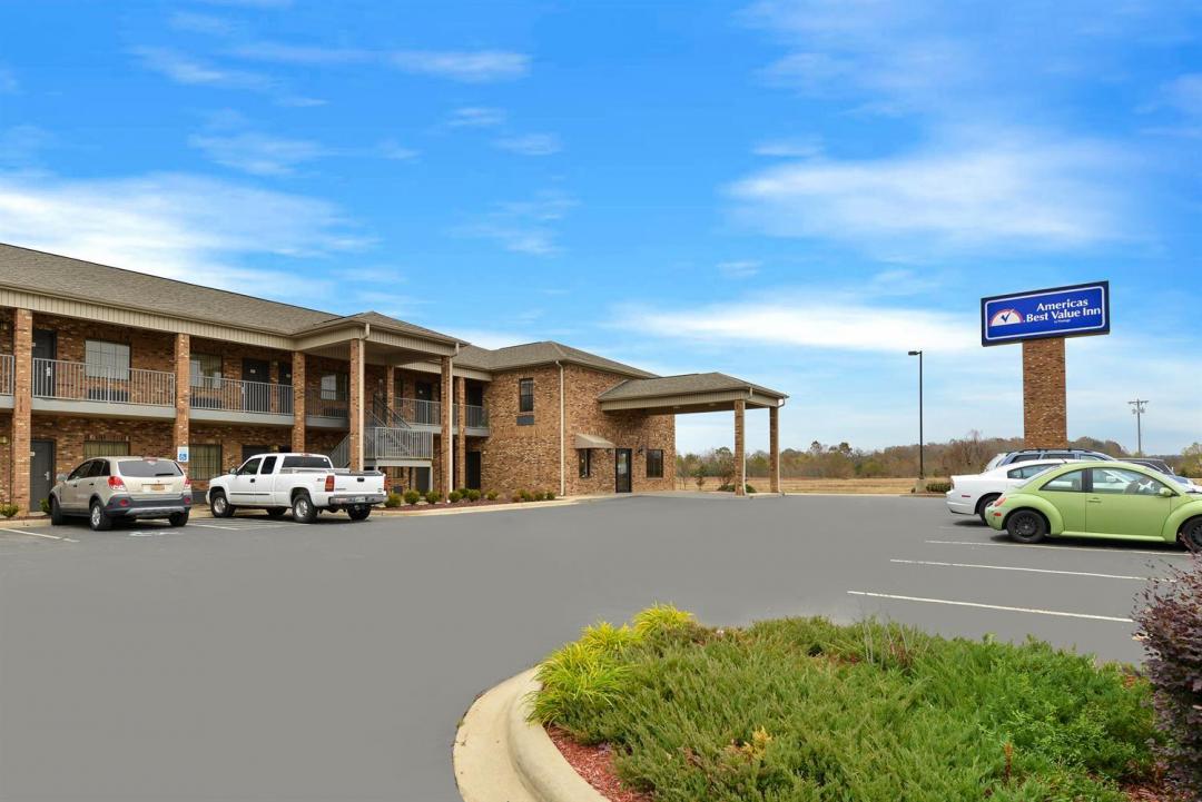 Hotel exterior with parking lot and sign