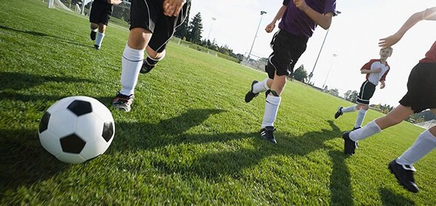 Sports Certified Hotel in Minot, ND, image showing soccer players in the grass field playing soccer