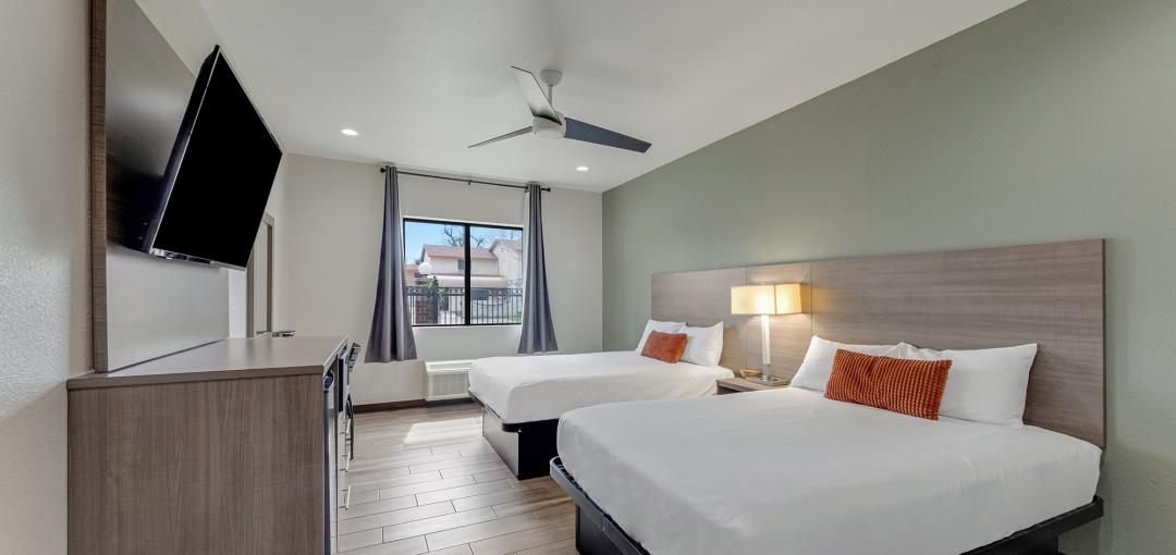 A room with two beds at the Americas Best Value Inn San Antonio Downtown Riverwalk hotel.