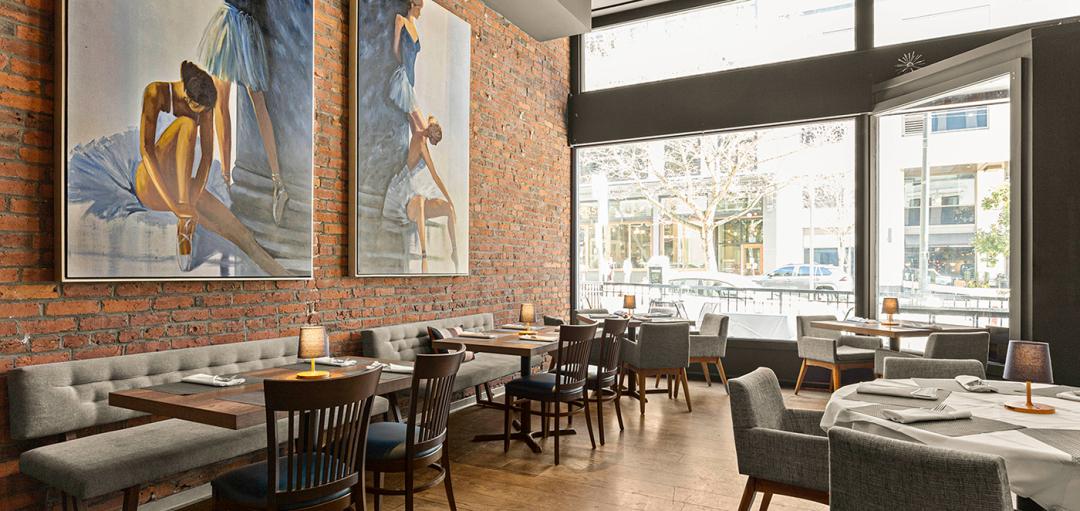 Elegant restaurant interior with large paintings.